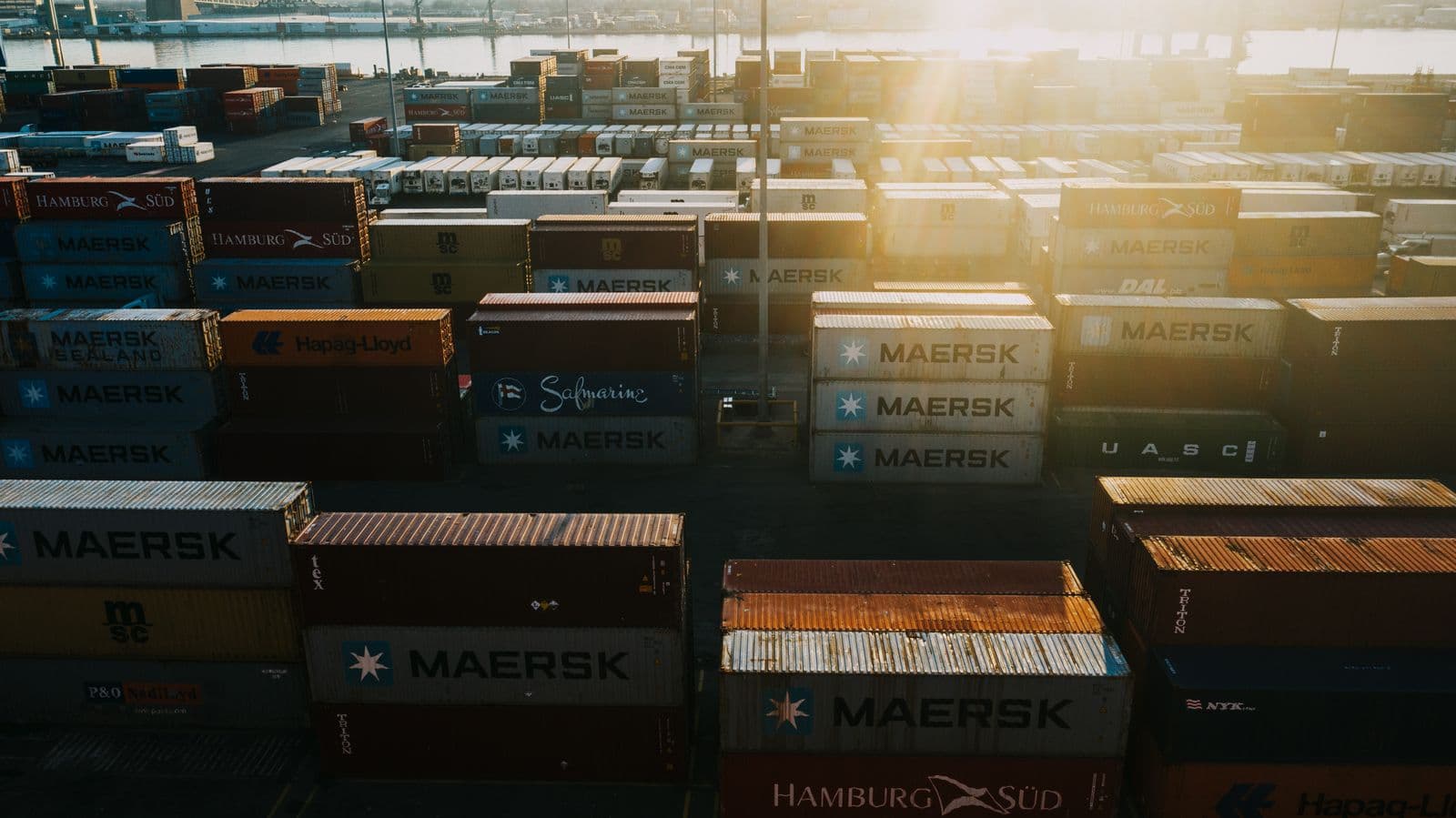 Shipping containers organized in rows at a logistics terminal