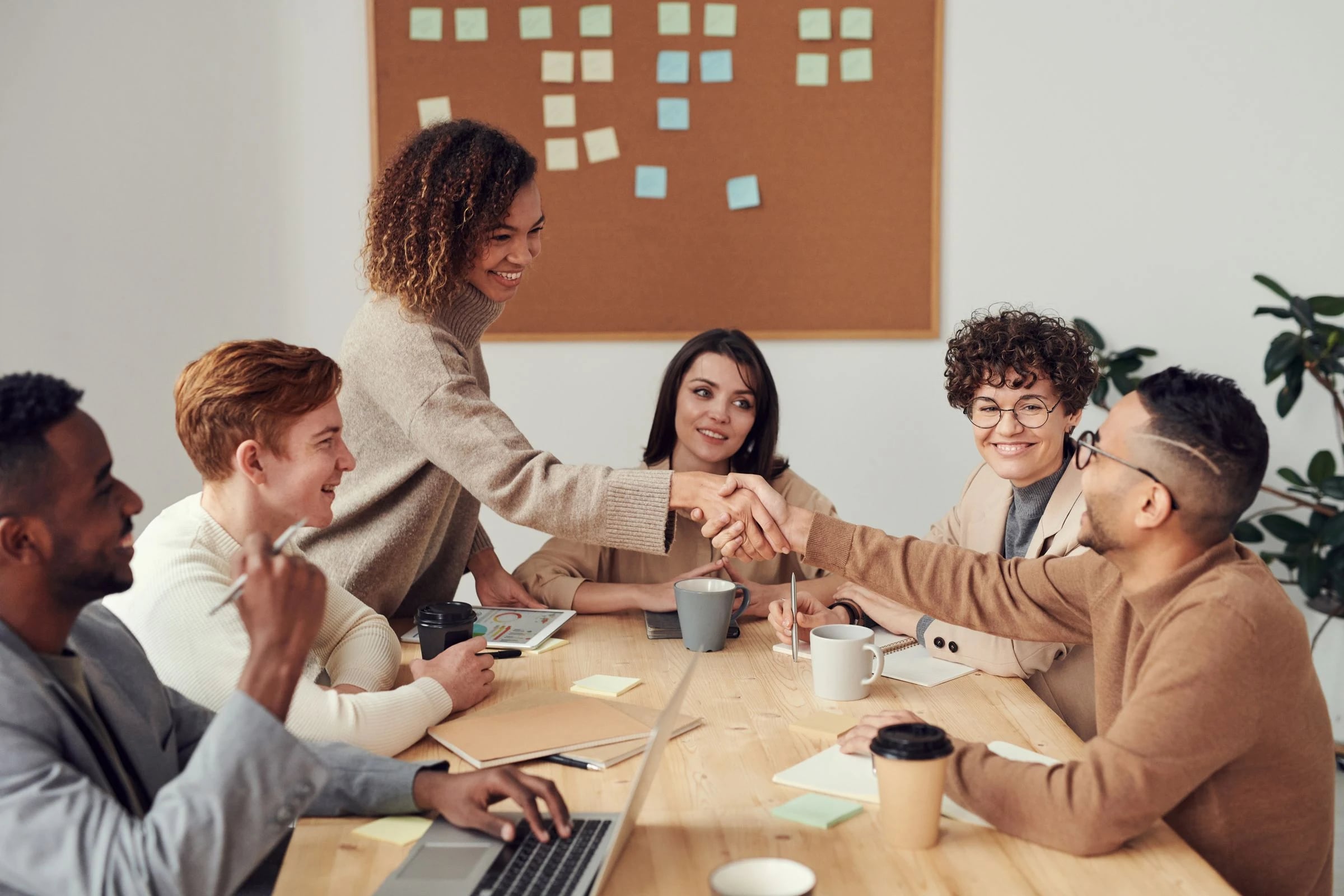 Colleagues discussing work around a conference table