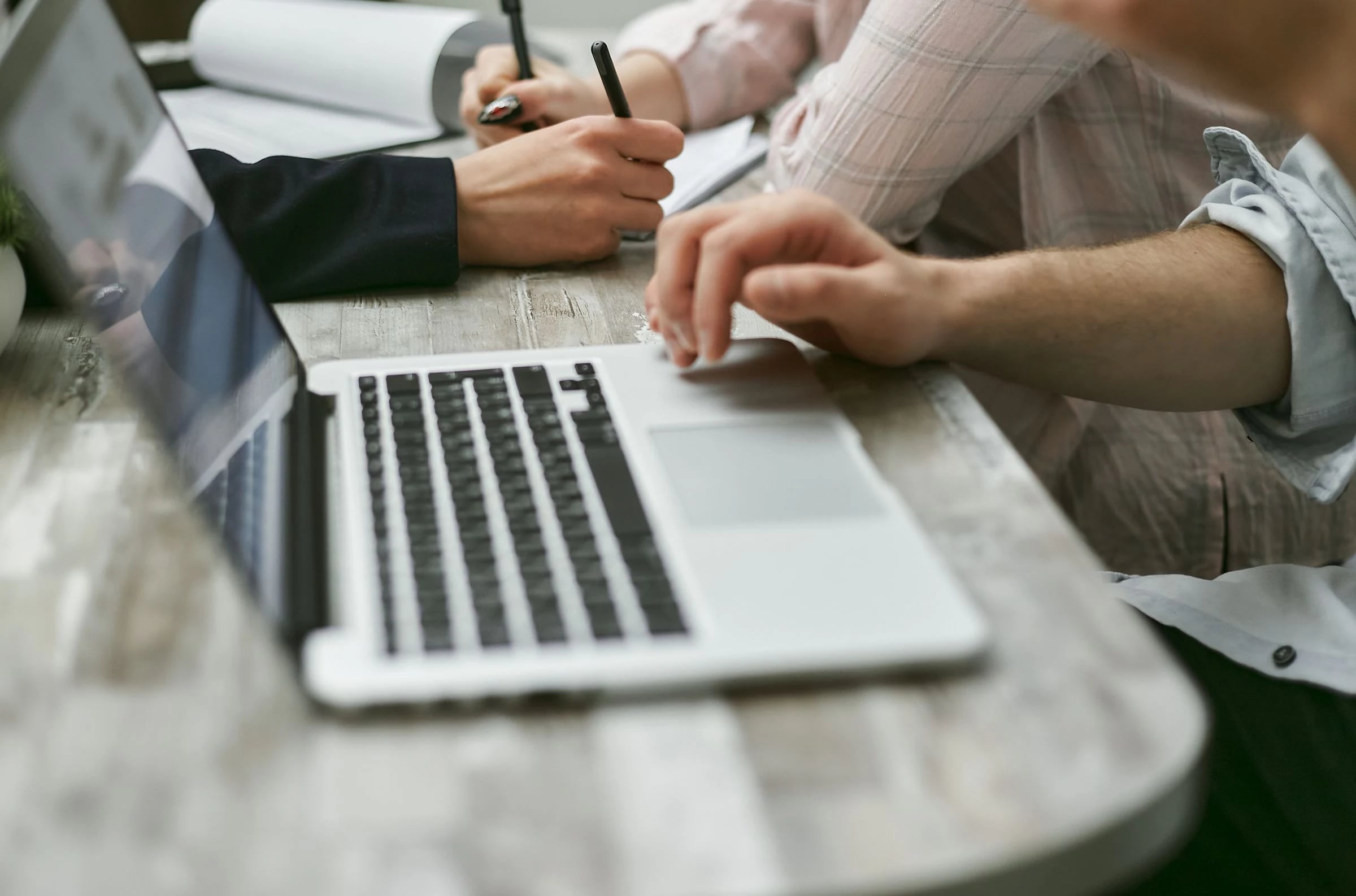 A laptop and documents during a working discussion