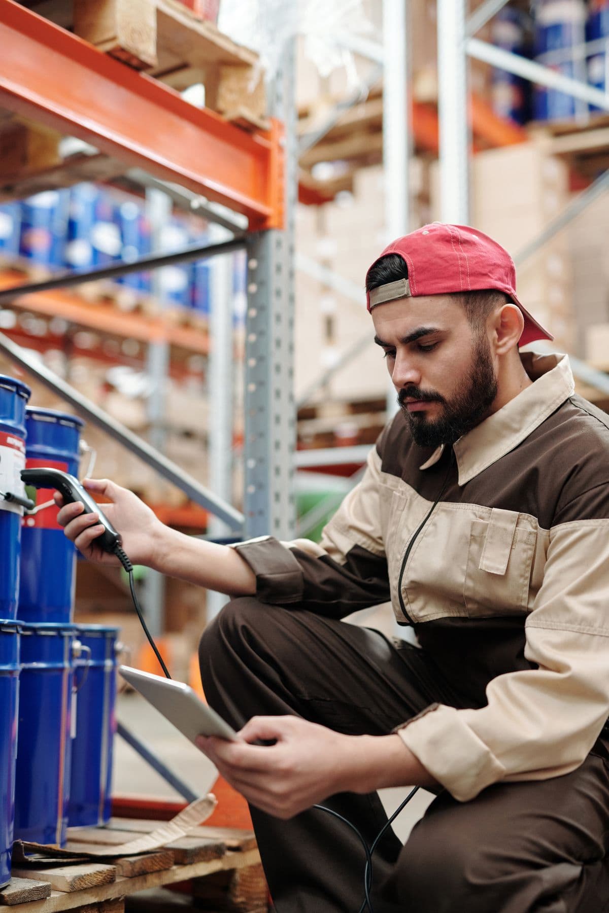 Warehouse employee checking stock with a digital tablet
