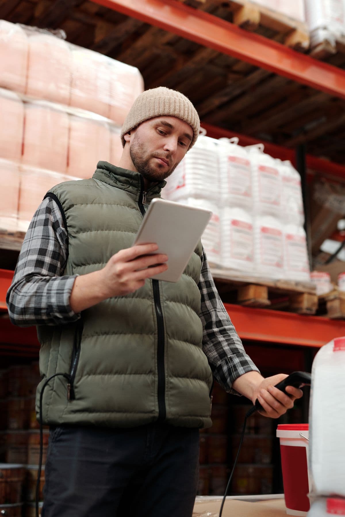 Employee reviewing warehouse inventory information