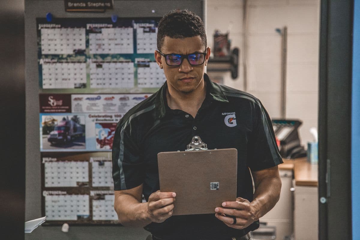 A warehouse employee checking a clipboard